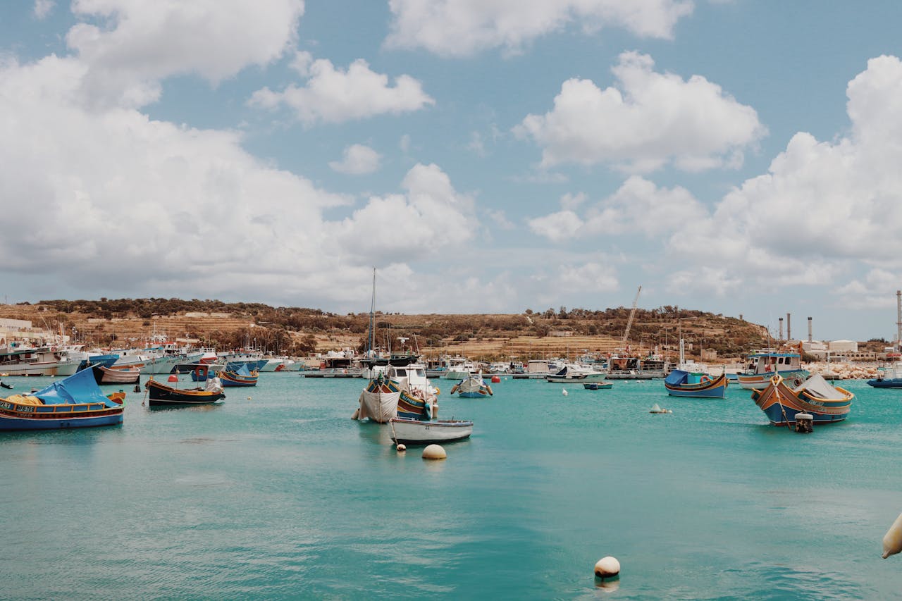 Scenic view of vibrant fishing boats in Marsaxlokk, a picturesque village in Malta.