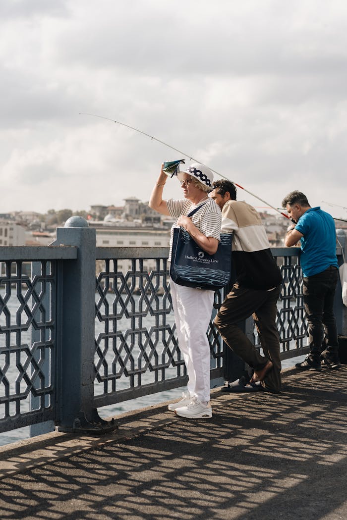 People fishing on the iconic Galata Bridge in Istanbul, Türkiye.
